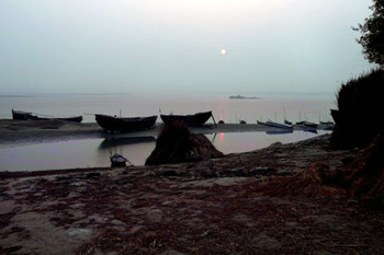 moon over boats on Ganges river