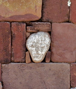 stone face within ancient wall