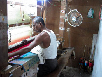weaver working silk loom