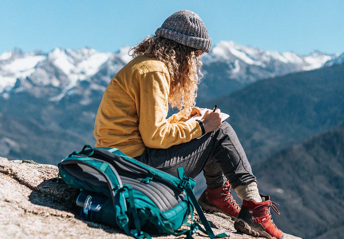 Woman writing travel journal