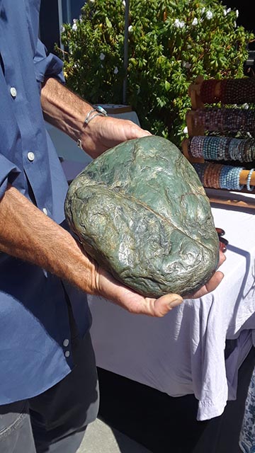 man holding large jade rock
