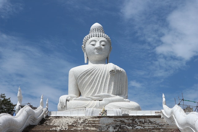 big buddha statue under blue skies