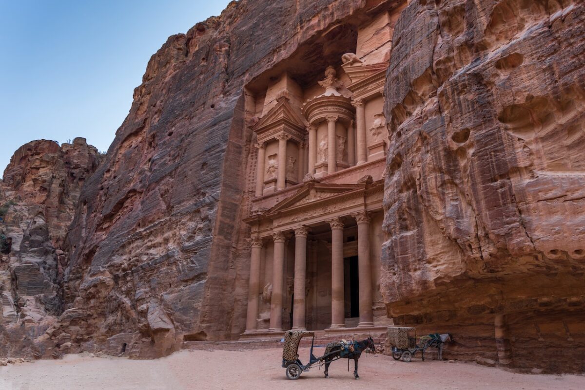 a horse with a trailer in front of Petra