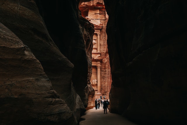 a view of the Treasury through the narrow Siq on a journey to Petra