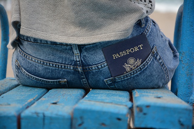 passport sticking out of man's jeans pocket