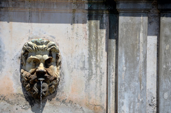 Old fountain on side of Rome building