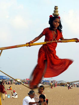 girl on tightrope on Marina Beach, Chennai