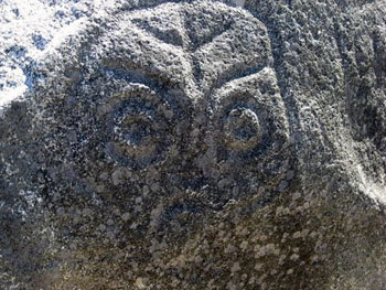 petroglyph - face carved on stone