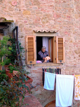 woman hanging laundry from window