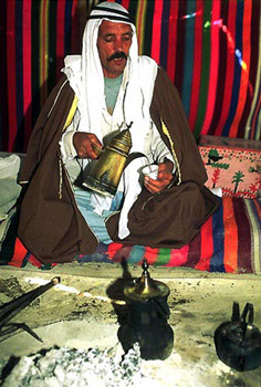Bedouin man pours tea