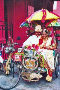 colorfully dressed couple posing for wedding photos