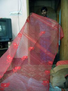 displaying a Jamdani sari
