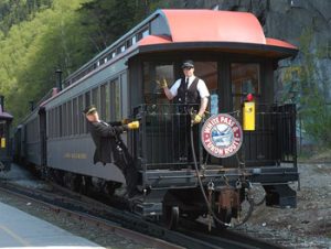 conductor and brakeman on White Pass & Yukon train car