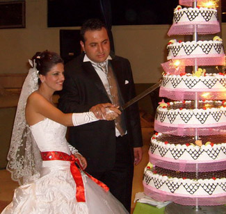 bride and groom cut cake at Turkish wedding