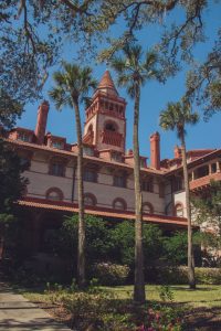 red and white building with palm trees
