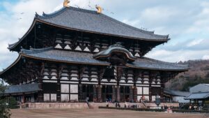 A flock of birds flying above the Great Buddha Hall.