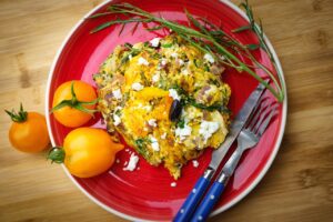 Greek moussaka on a plate with tomatoes