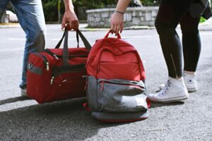 Two people holding bags after packing for a trip to explore the ancient cultures of Mesa Verde.