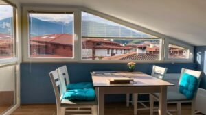 Apartment interior with mountain view outside the window.