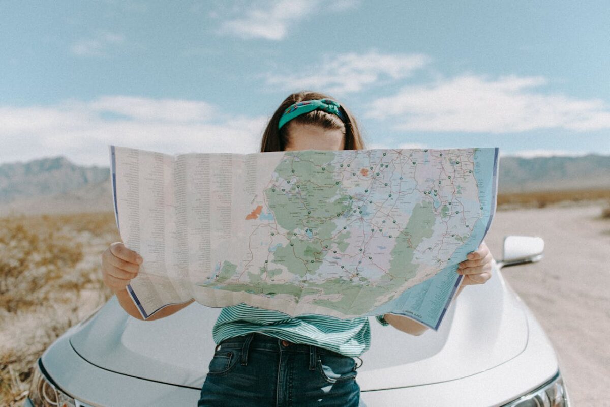 Woman reading map on a road