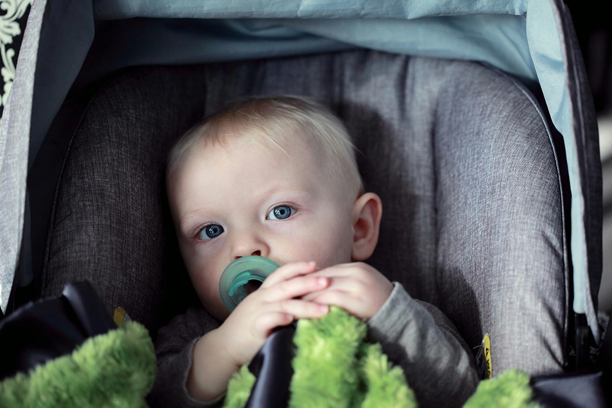 newborn baby in carrier