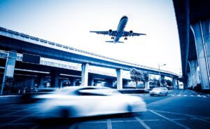 plane flying over street