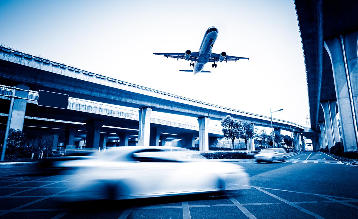 plane flying over street