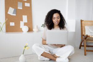 Person looking at a laptop smiling