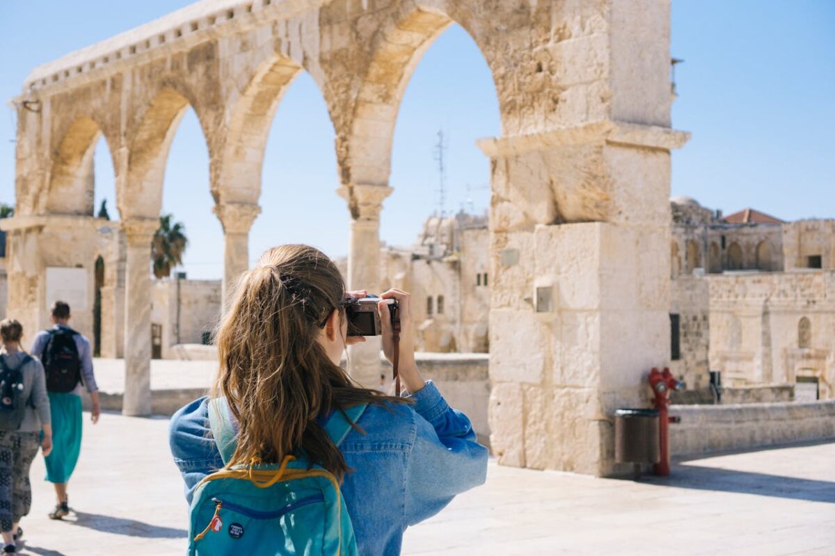 Woman taking photos of monuments, ruins