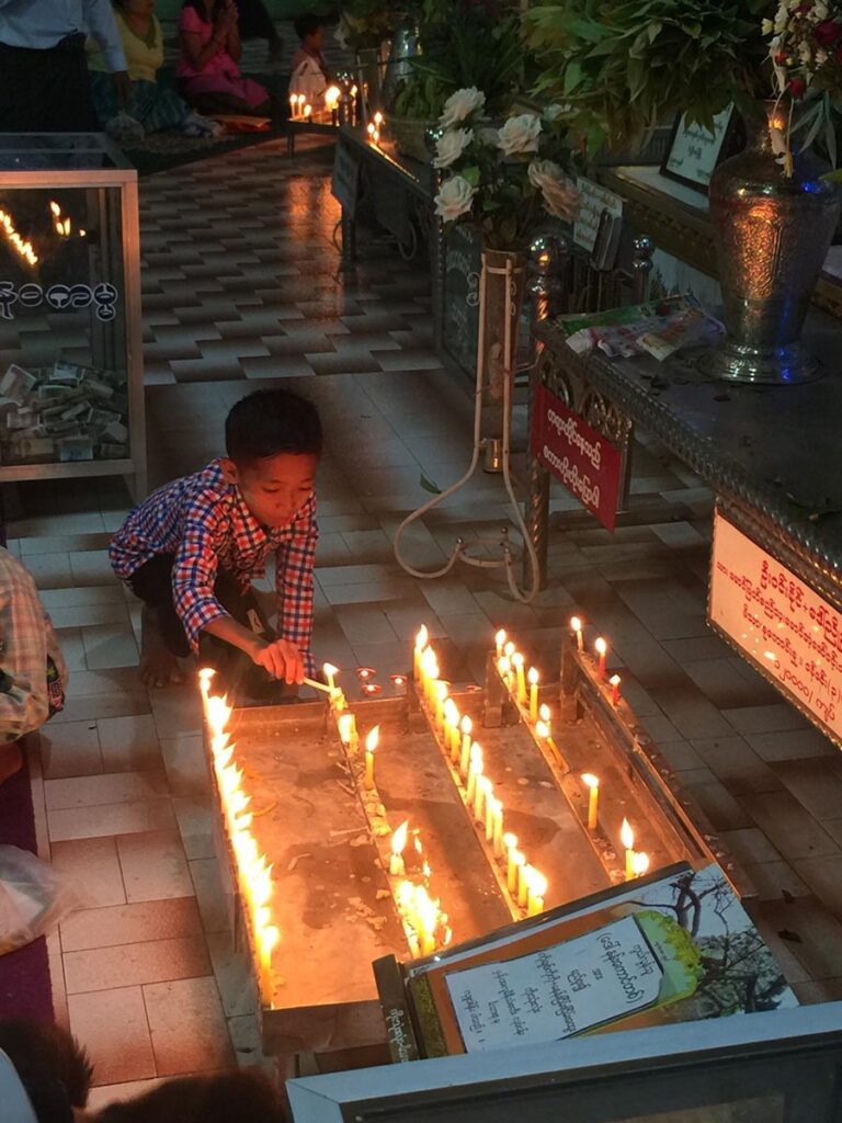 Boy lighting candles