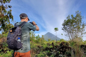 man photographing volcano