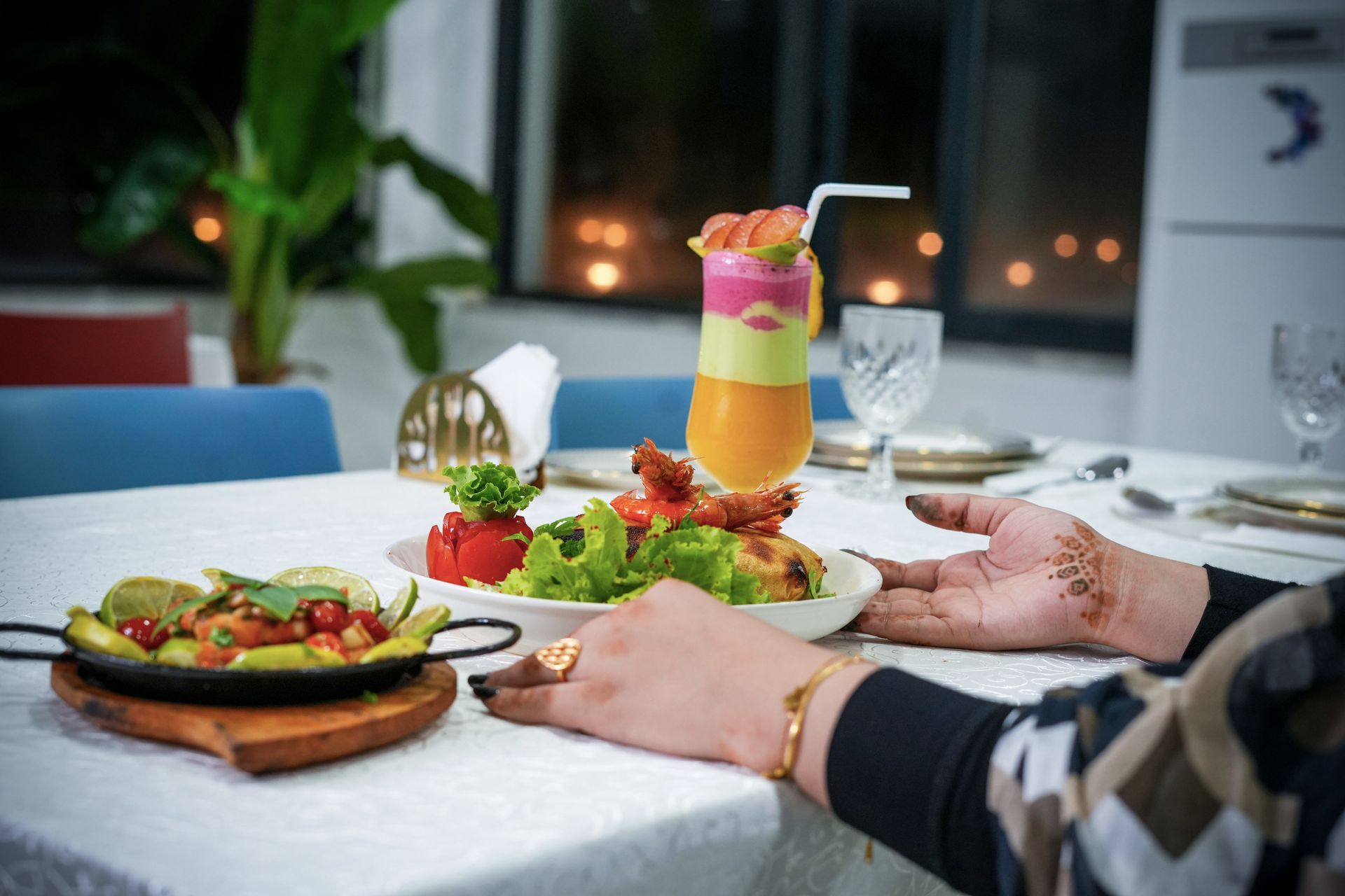 woman sitting at the table and touching a food plate