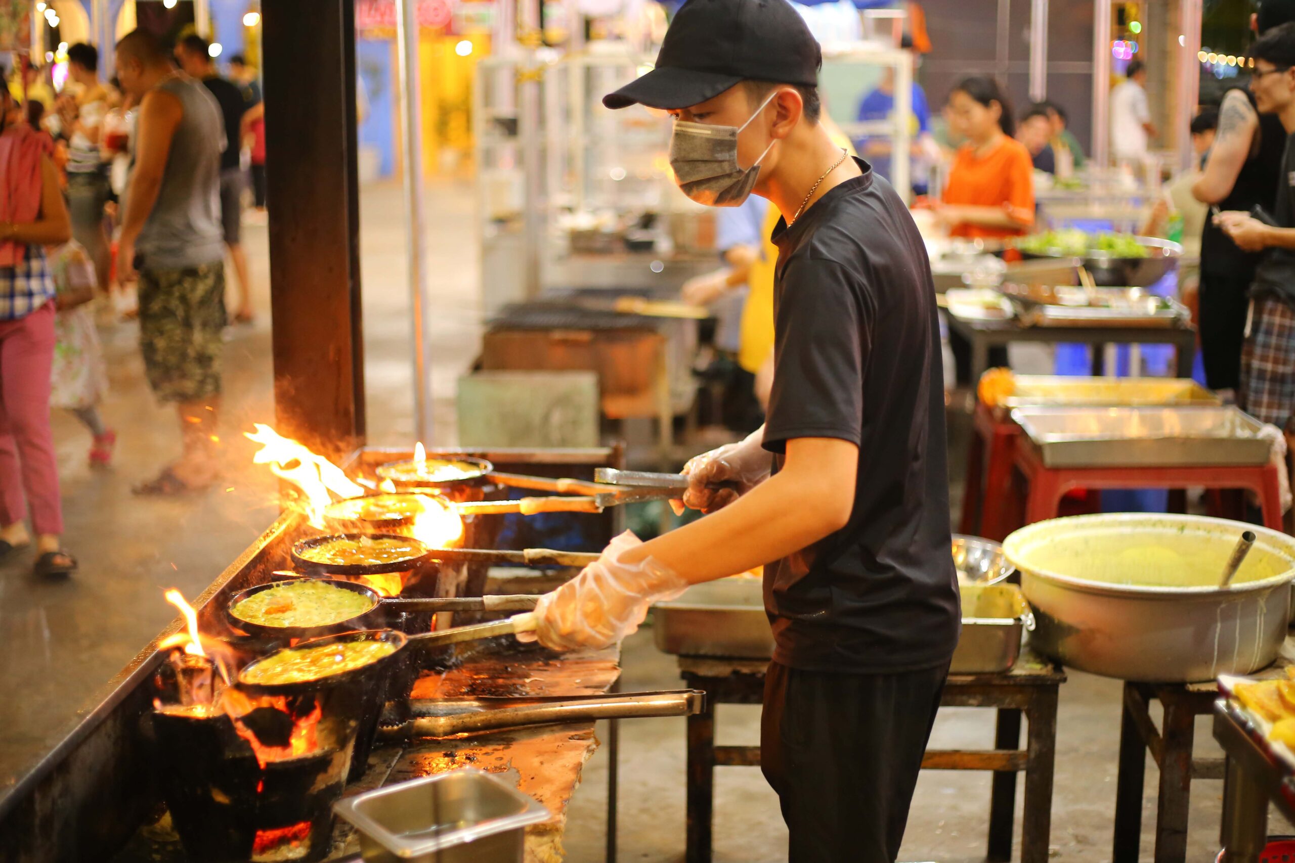 man cooking in Vietnam market stall